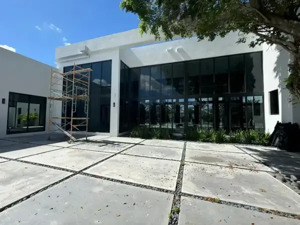 Large fixed impact glass panels across a modern South Florida elevation