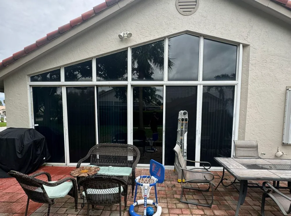 Impact sliding patio doors under a gable end, with fixed glass above the head