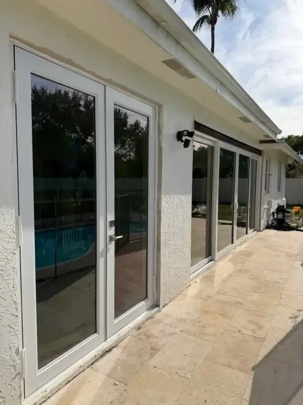 Hurricane impact sliding glass doors by pool in Weston, FL