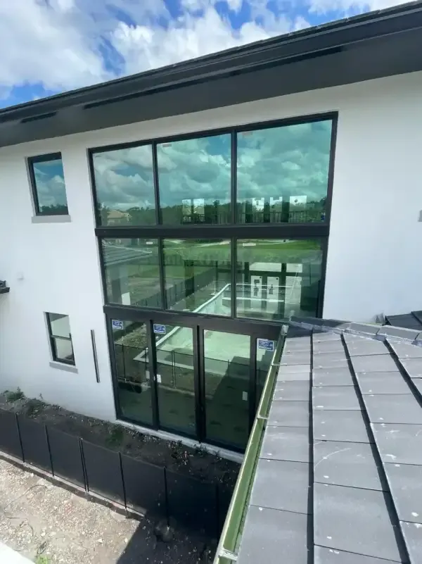 Two-storey wall of hurricane impact windows and sliding doors on a South Florida home