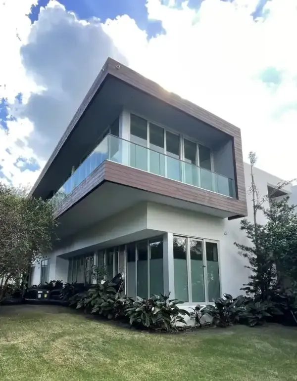Two-story home with wood cladding and impact windows in Palm Beach Gardens